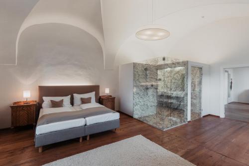 a bedroom with a bed and a glass shower at Freigut Thallern in Gumpoldskirchen