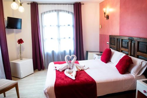 a bedroom with a bed with a towel on it at Posada la Leyenda in Santillana del Mar