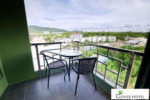 a balcony with a table and chairs and a view at Clover Hotel Hatyai in Hat Yai