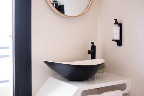 a black and white bath tub sitting on a table in a bathroom at Hôtel de la Plage in Sète