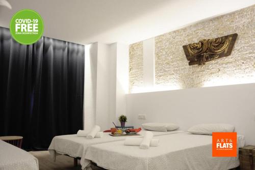two beds in a room with a green advertisement for milk farms at Art&Flats Hostel in Valencia