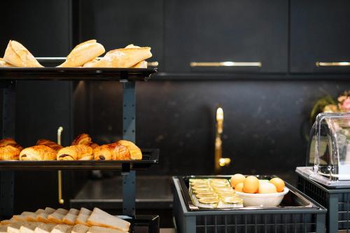 a bakery with bread and croissants and other foods at Hôtel de la Plage in Sète