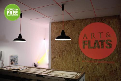 a room with a table and a sign on the wall at Art&Flats Hostel in Valencia