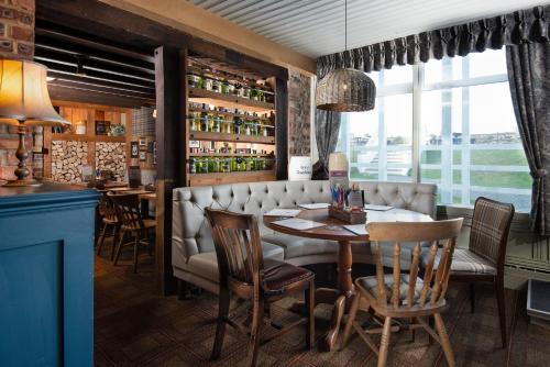 a dining room with a table and chairs at The Bamburgh Castle Inn - The Inn Collection Group in Seahouses