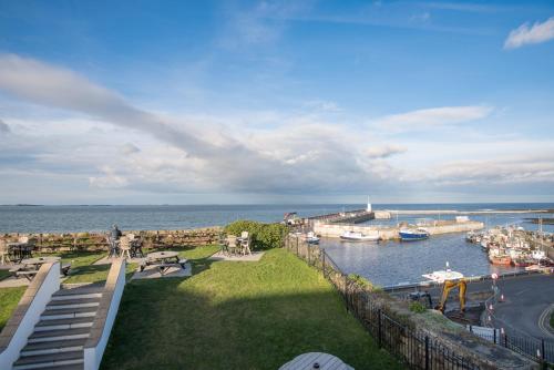 a view of a marina with boats in the water at The Bamburgh Castle Inn - The Inn Collection Group in Seahouses