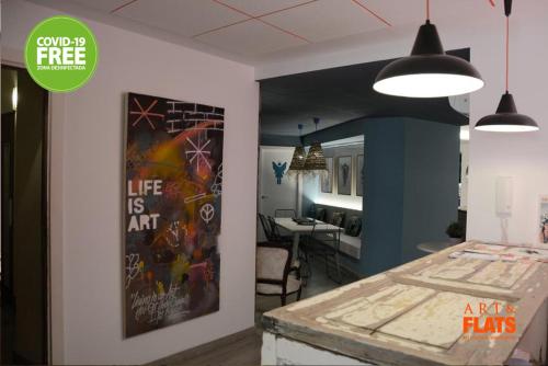 a room with a painting on the wall and a table at Art&Flats Hostel in Valencia
