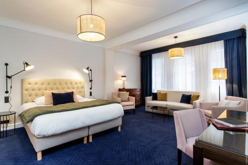 Postel nebo postele na pokoji v ubytování Le Manoir Hôtel