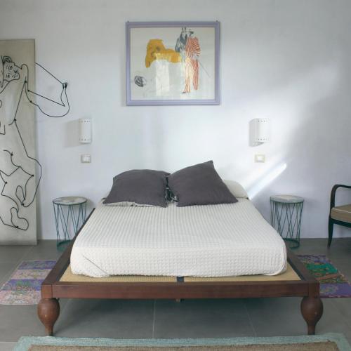 a bed in a room with a white mattress at La Grechea Boutique B&B in Casa Alzi