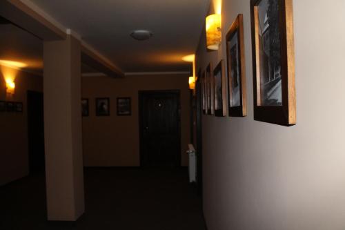 a hallway with pictures on the walls of a room at Dobry Czas in Sandomierz