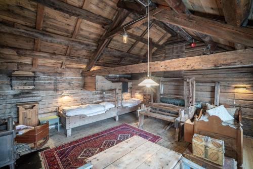an attic room with a bed and a table at Håholmen - by Classic Norway Hotels in Karvåg