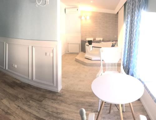 a living room with a table and a chair at Spa-Hotel Myslyvskiy Dvir in Kyiv