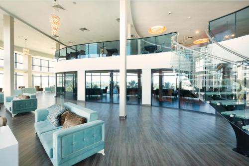a lobby with a blue couch in a building at King Sky Tower Hotel in Batumi