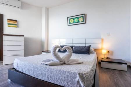 two swans are forming a heart on a bed at Torresol in Nerja