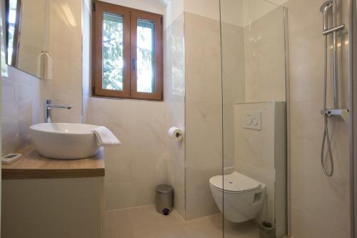 
a bathroom with a toilet, sink, tub and shower at Hotel Villa Diana in Split
