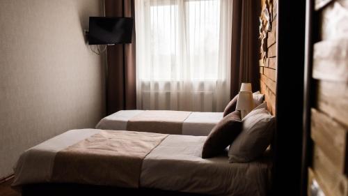 
A bed or beds in a room at Vishnevyi sad
