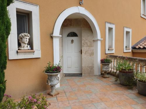una puerta delantera de una casa con una estatua en una ventana en Montèze Paradis en Saint-Christol-lès-Alès