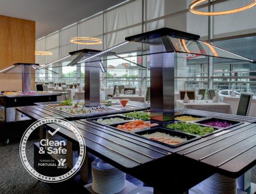a buffet of food on a table in a restaurant at VIP Executive Azores Hotel in Ponta Delgada