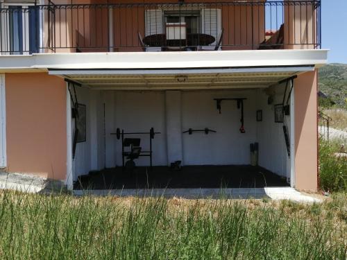 an empty garage with a balcony and weights at Sunny Coco mat villa in Katelios with a sea view in Katelios
