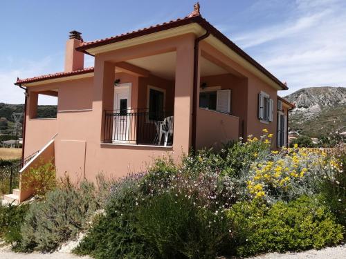 a small house with a balcony in a garden at Sunny Coco mat villa in Katelios with a sea view in Katelios