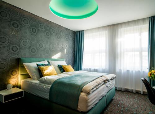 a bedroom with a large bed with a blue ceiling at Rooftop Planet Prague Hotel in Prague