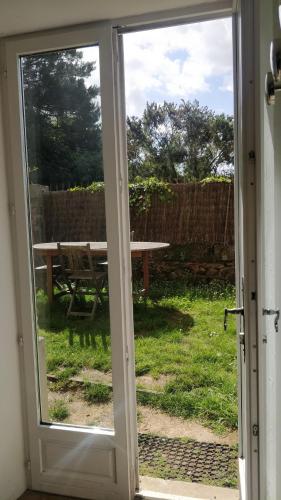 an open door with a view of a picnic table at Domaine de Keravel in Plouha