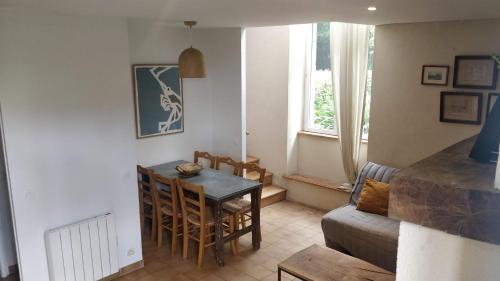 a living room with a table and a couch at Domaine de Keravel in Plouha