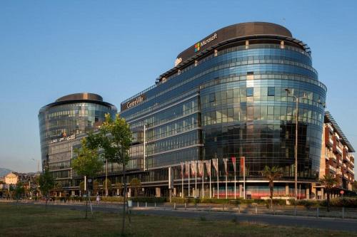 a large glass building with a lot of windows at Apartment Temple in Podgorica