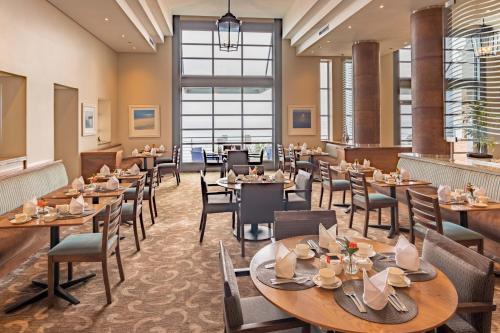 a restaurant with tables and chairs in a room at Town Lodge Gqeberha in Port Elizabeth