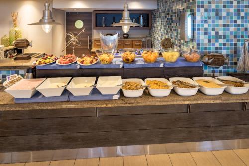 a buffet with many different types of food on a counter at Town Lodge Gqeberha in Port Elizabeth