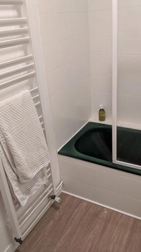 a bathroom with a bath tub and a towel at L´Aveneau in Le Retail