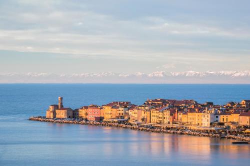 a group of buildings on the shore of the water at Vila Piranesi Apartments in Piran