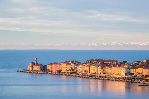 a group of buildings on the shore of the water at Vila Piranesi Apartments - Parking included in Piran