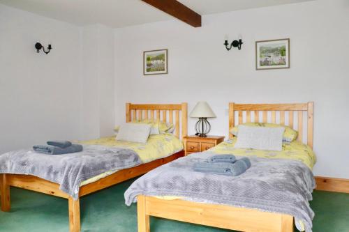 Katil atau katil-katil dalam bilik di Old Camms Holiday Cottages