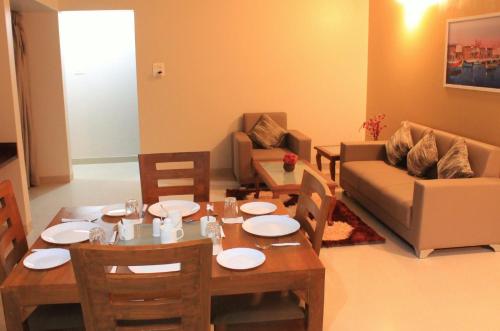 a living room with a table and a couch at StayBird - Icon Bliss, An Apartment Hotel, Kharadi in Pune