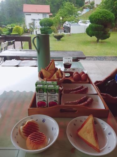 a tray of food on a table with a plate of food at Namhea German Village Beethoven House in Namhae
