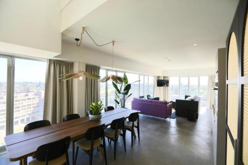 a living room with a dining room table and chairs at Cityden BoLo District in Amsterdam