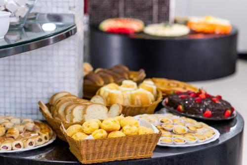 a table topped with lots of different types of pastries at Brasilia Park Hotel in Brasília