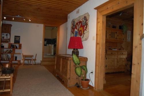 a living room with a red lamp on a wall at Chasa Städler - Ferienwohnung mit 113m2 für max. 5 Personen in Zernez