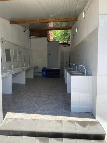 a large bathroom with sinks and toilets in it at Villaggio Togo Togo in Vulcano