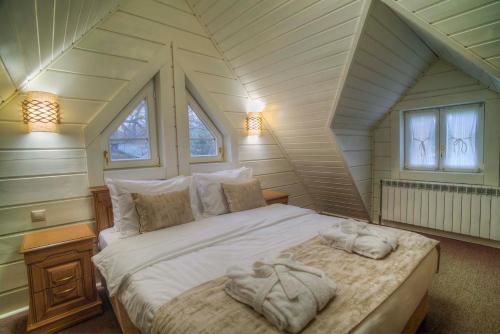 a bedroom with a bed with towels on it at RIVER INN RESORT AND SPA in Nabran
