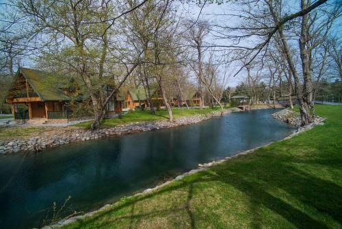 a house next to a river with a house at RIVER INN RESORT AND SPA in Nabran