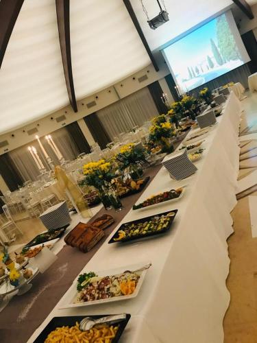 a long table with many plates of food on it at Sunshine Club Hotel Centro Benessere in Ricadi