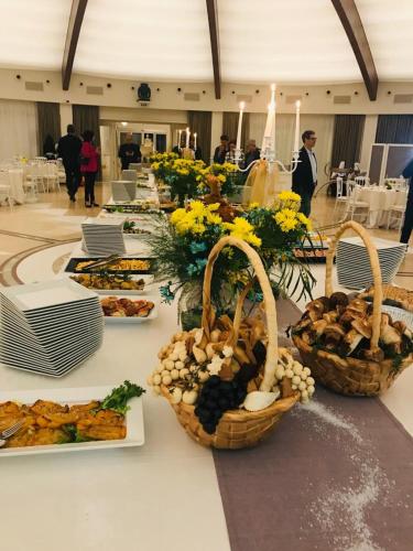 a buffet with baskets of food on a table at Sunshine Club Hotel Centro Benessere in Ricadi