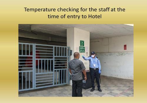 a man standing next to a man standing next to a gate at Hotel Deccan Serai, HITEC CITY, HYDERABAD in Hyderabad