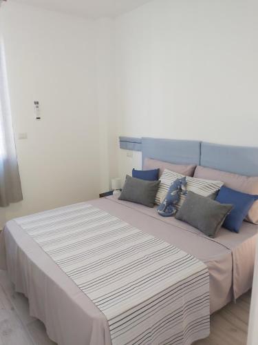 a large bed with pillows on it in a room at JRG APARTMENTS in Porto Torres