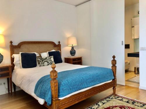 a bedroom with a bed with a blue blanket at Lisbon Chiado One in Lisbon