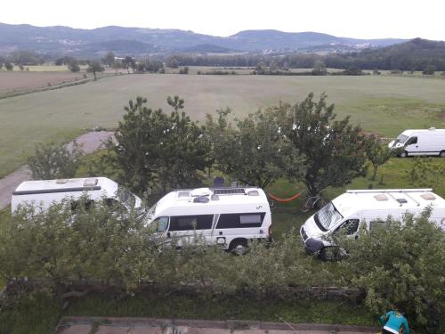 a group of three rvs parked in a field at Turistična kmetija Pri Rebkovih in Ajdovščina