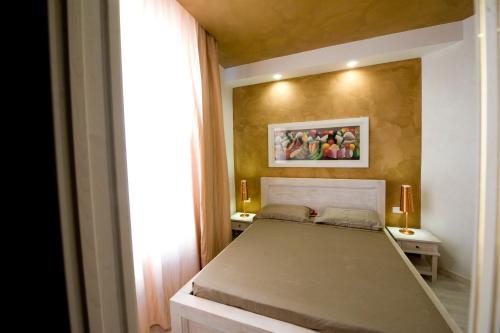 a small bedroom with a bed and a window at White House in Trani