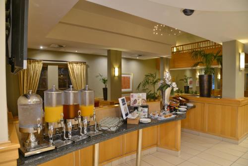 a kitchen with a counter with orange juice at Road Lodge Sandton in Johannesburg