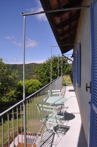 a patio with tables and chairs on a balcony at Casa Langa di Lola in Mango